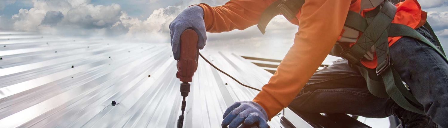 Roofing contractor working on installing a roof