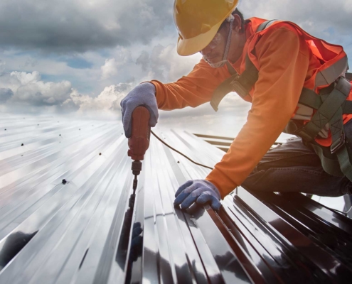 Roofing contractor working on installing a roof